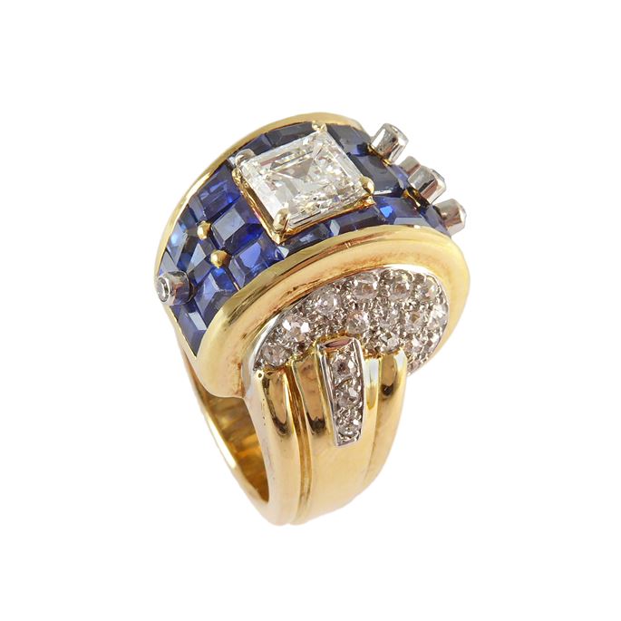 Diamond, sapphire and gold stepped bombe ring, French, workshop mark for Henri Lavabre, in the form of a broad arching scroll pave set with calibre sapphires and topped by a carre cut square diamond, approximately 1.45ct, | MasterArt